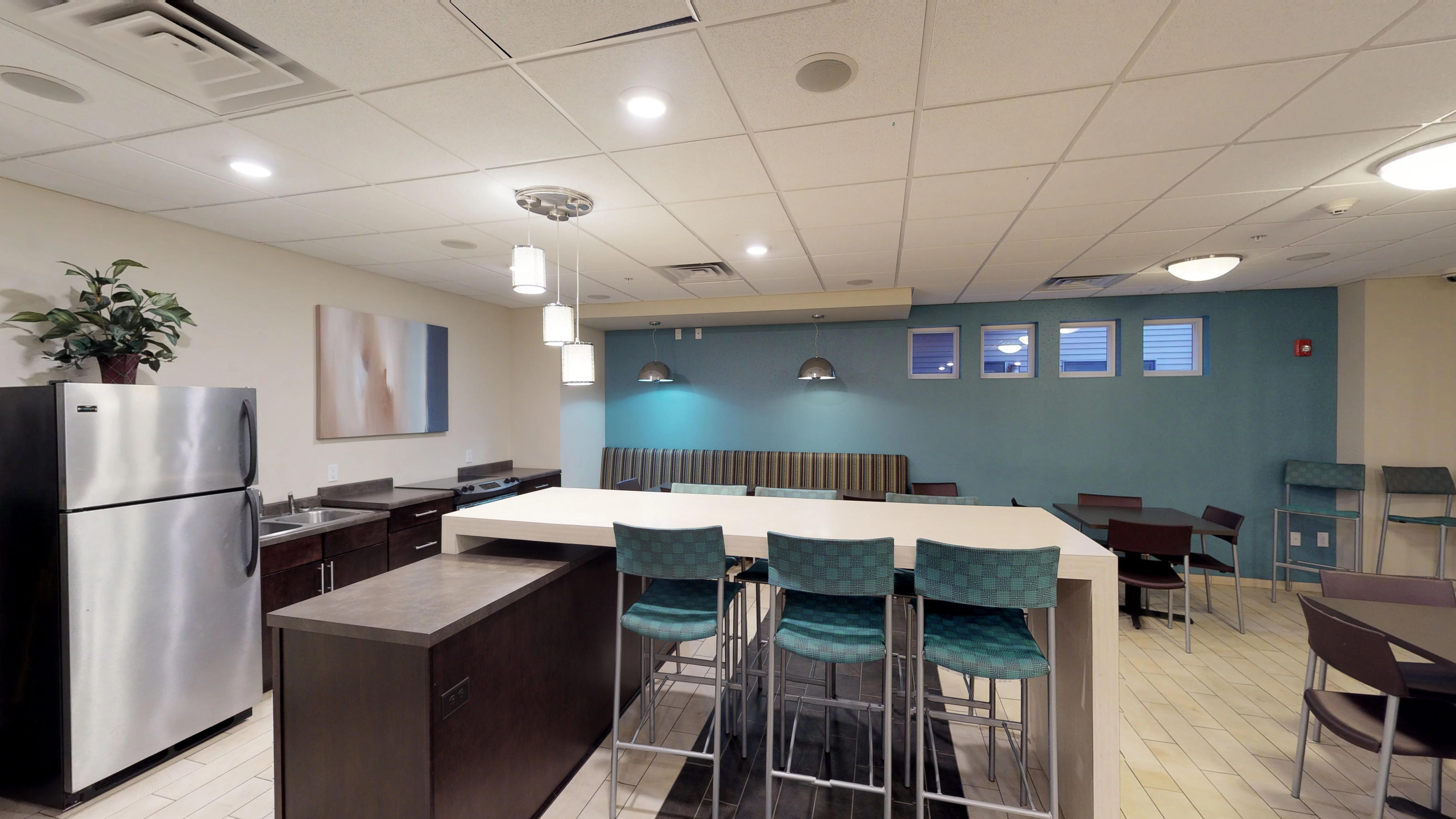 A kitchen with a table and chairs in the middle of the room.